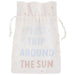 Cream-colored drawstring pouch with light blue and dusty rose text reading "TRIP AROUND THE SUN" and scattered star details throughout.