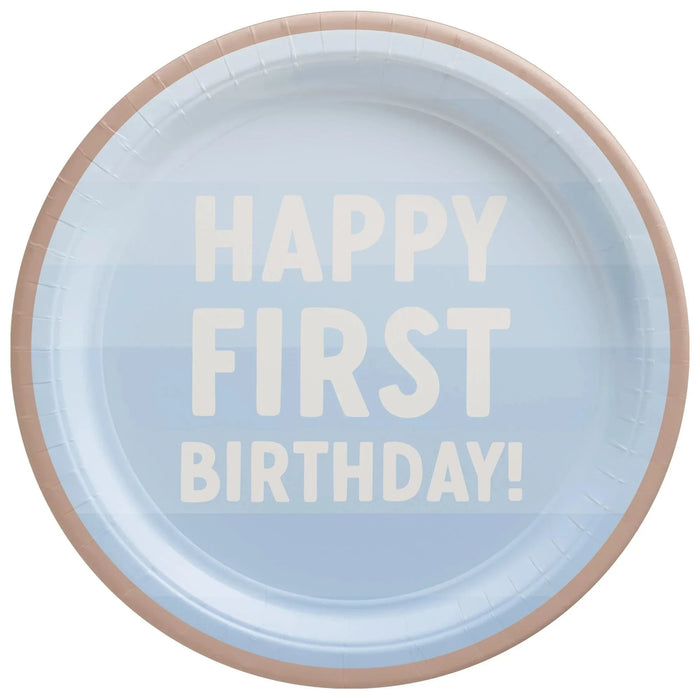 Light blue paper plate with tan rim featuring cream-colored text reading "HAPPY FIRST BIRTHDAY!" in large letters.
