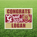 Burgundy and gold yard sign with "CONGRATS Grad 2026 LOGAN" text and a growling bear mascot head design.