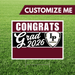 Graduation-themed customizable sign with 'Congrats Grad 2026' text on a grass background