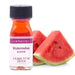 Bottle of watermelon flavoring extract with purple label next to fresh watermelon slices showing red flesh and green rind.