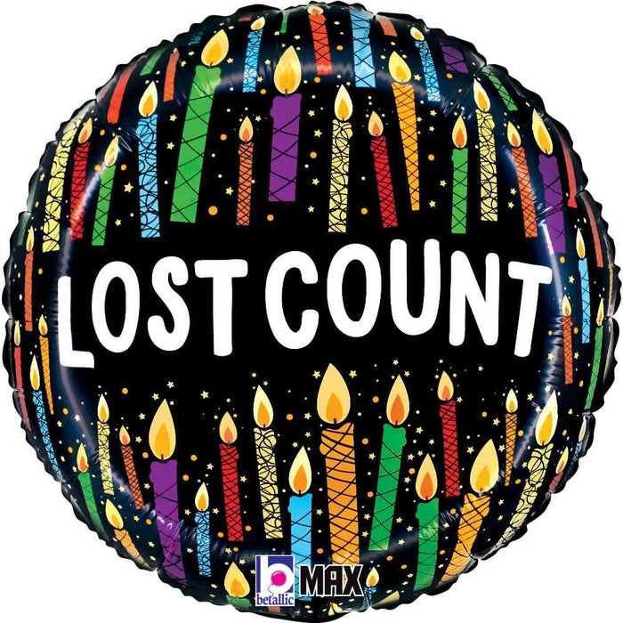 Round black mylar balloon with colorful vertical stripes in red, blue, green, purple, and orange, decorated with yellow flame candles and small stars, displaying "LOST COUNT" in white text.