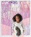 Young woman smiling at camera holding a silver balloon against a pink and purple striped metallic fringe backdrop.
