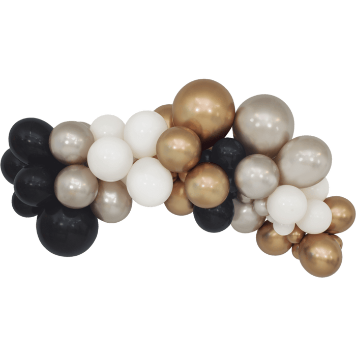 Cluster of glossy spheres in black, white, champagne gold, and silver arranged in a curved garland formation against a white background.