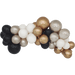 Cluster of glossy spheres in black, white, champagne gold, and silver arranged in a curved garland formation against a white background.