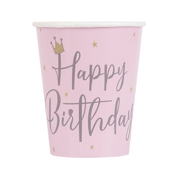 Pink disposable cup featuring "Happy Birthday" in gray script text with a gold crown and stars design.
