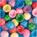 Colorful assorted marble poppers arranged on a blue background, including red, pink, blue, green, and yellow translucent spheres with globe designs.