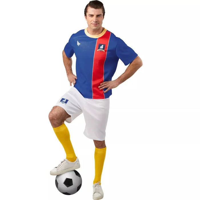Man wearing a blue and red striped soccer jersey with yellow collar, white shorts, and yellow socks while posing with a soccer ball.