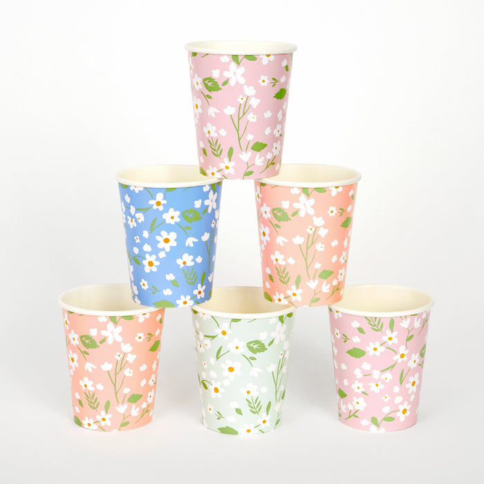 Ditsy Floral Cups in assorted pink, peach, mint, and blue colors with white daisy prints and green leafy details stacked on a white background.