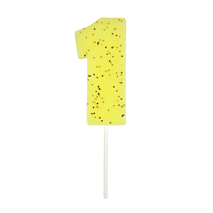 Yellow number 1 cake candle with gold speckle accents and white pick on a white background.