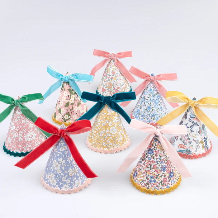 Liberty Floral Party Hats with assorted floral prints, scalloped trim, and colorful ribbon bows.
