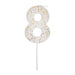 White number 8 cake candle with gold speckle accents and white pick on a white background.