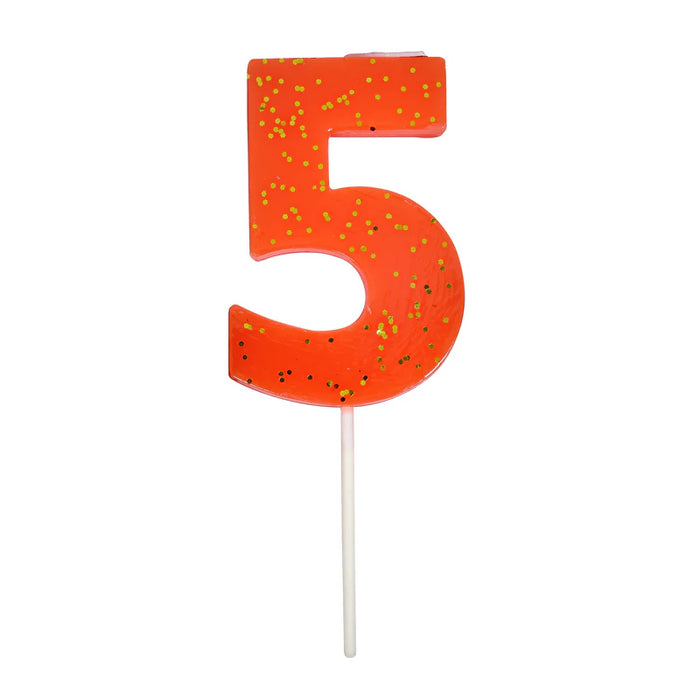 Coral number 5 cake candle with gold speckle accents and white pick on a white background.