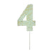 Pale mint green number 4 cake candle with gold speckle accents and white pick on a white background.