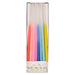Rainbow Dipped Tapered Candles in clear packaging with white candles dipped in assorted bright colors.