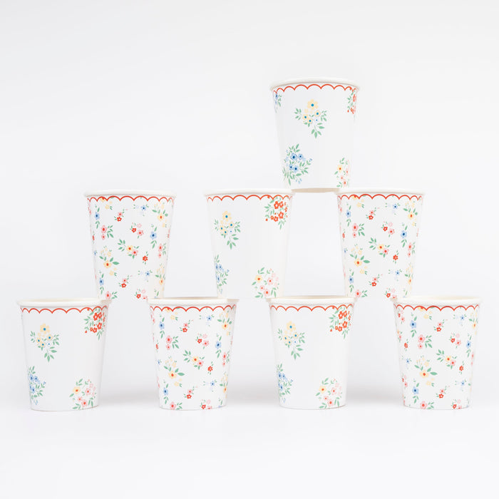 Ditsy Posy Scalloped Cups with tiny multicolor floral prints, green leaves, and red scalloped rim details stacked on a white background.