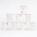 Ditsy Posy Scalloped Cups with tiny multicolor floral prints, green leaves, and red scalloped rim details stacked on a white background.