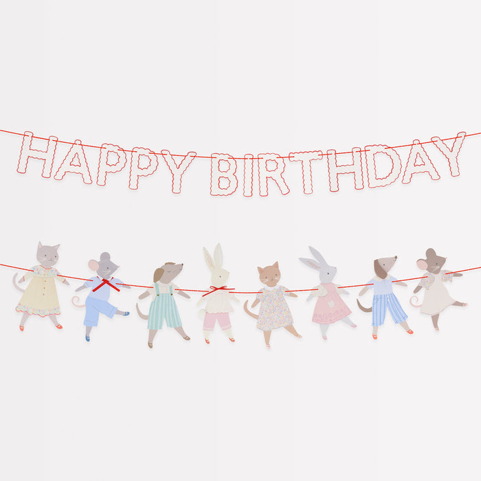 Animal Friends garland with red Happy Birthday letters and illustrated animal characters strung on red cord.