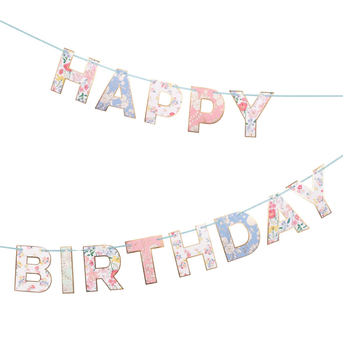 English Garden Birthday Garland with floral-patterned “Happy Birthday” letters, gold-tone edging, and light blue string on a white background.