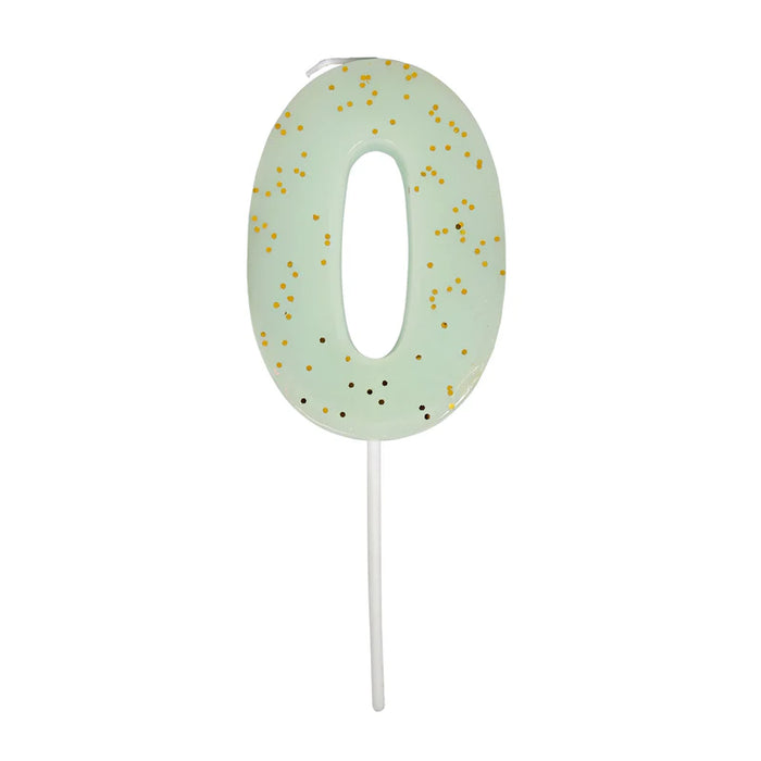 Pale mint green number 0 cake candle with gold speckle accents and white pick on a white background.