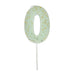 Pale mint green number 0 cake candle with gold speckle accents and white pick on a white background.