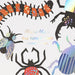 Making Magic Large Bug Confetti with oversized colorful insect cutout pieces, including beetles, spiders, and caterpillar designs on packaging.