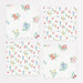 Ditsy Posy Scalloped Small Napkins with tiny multicolor floral prints, green leaves, and scalloped edges on a white background.