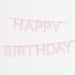 Pink scalloped Happy Birthday garland with pale pink letters strung on coordinating twine.