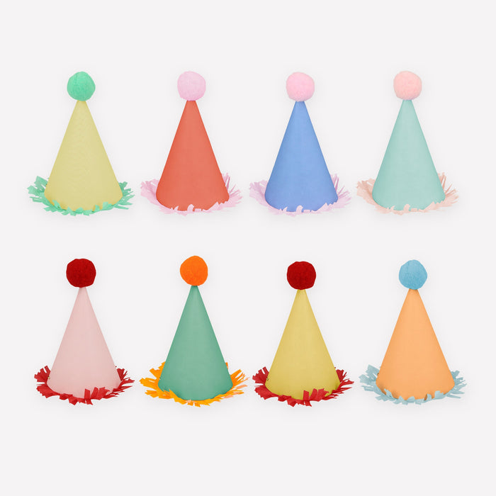Mini Party Hats in assorted pastel colors with fluffy pom-pom toppers and fringed paper trim on a white background.