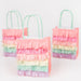 Meadow Unicorns Fringe Party Bags with layered pastel tissue fringe in pink, peach, cream, mint, and lavender with mint green handles.