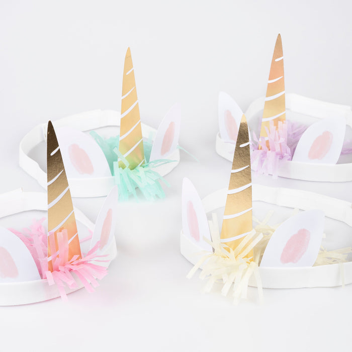 Meadow Unicorns Horn Headbands with white bands, unicorn ears, shiny gold horns, and pastel fringe accents.
