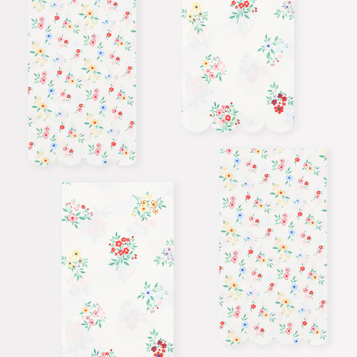Ditsy Posy Scalloped Guest Napkins with small colorful floral bouquets, green leaves, and soft scalloped edges.
