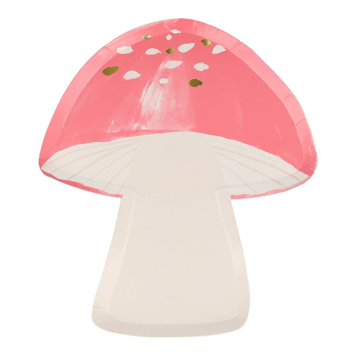 Fairy mushroom shaped plate with coral pink cap, cream stem, white spots, and small gold accents on a white background.