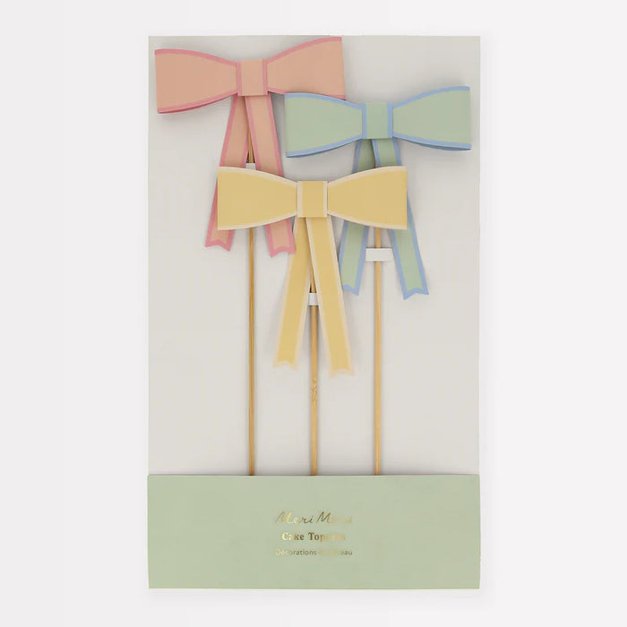 Pastel Bow Cake Toppers featuring peach, yellow, and mint paper bows on wooden picks in decorative packaging.