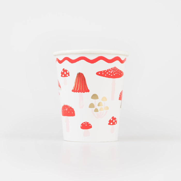 Merry Mushroom Cup with red mushroom illustrations, soft pink stems, gold accents, and a red wavy border.
