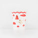 Merry Mushroom Cup with red mushroom illustrations, soft pink stems, gold accents, and a red wavy border.
