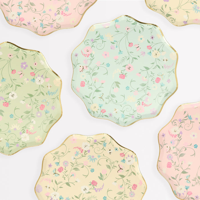 Ladurée Paris Floral Side Plates in assorted pastel colors with delicate floral patterns, butterfly details, and gold scalloped trim.