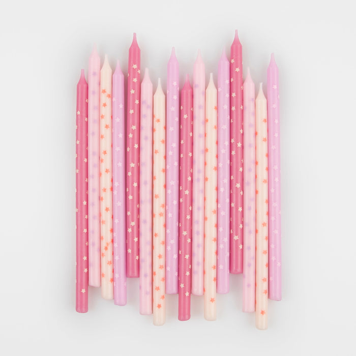 Pink Stars Candles arranged on a white background with assorted pink and cream birthday candles decorated with tiny star prints.