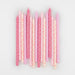 Pink Stars Candles arranged on a white background with assorted pink and cream birthday candles decorated with tiny star prints.