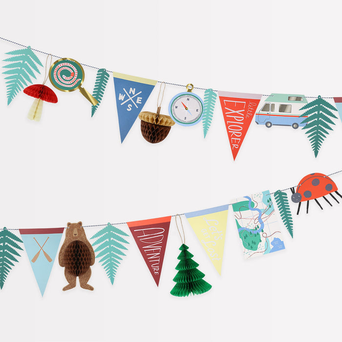 Outdoor Adventures Garland with colorful pennants, forest leaves, camper van, compass, honeycomb tree, bear, mushroom, acorn, and woodland details on a white background.