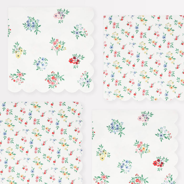 Ditsy Posy Scalloped Large Napkins with tiny multicolor floral prints, green leaves, and scalloped edges on a white background.