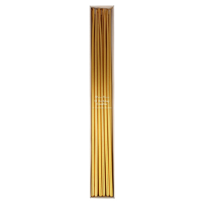 Gold tall tapered candles with a metallic finish arranged for elegant table décor.