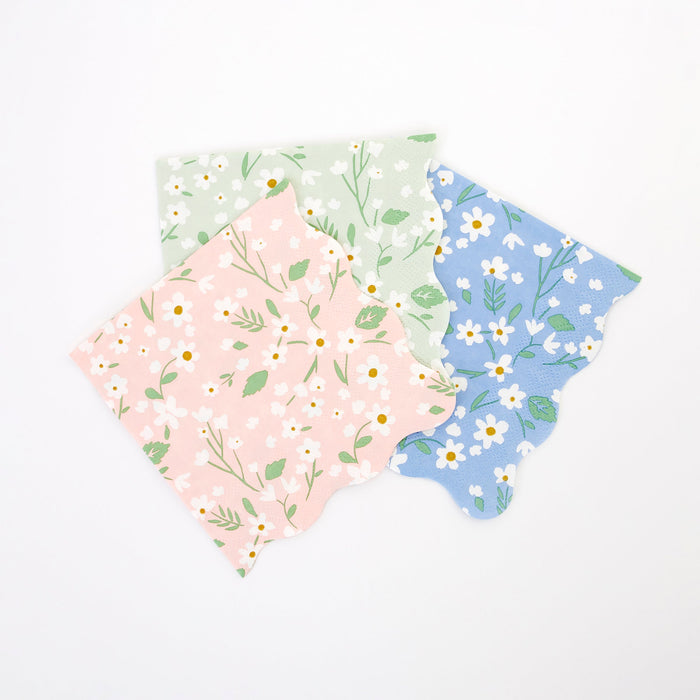 Ditsy Daisy Small Napkins in pastel pink, mint, and blue with white daisy prints, green leaves, and scalloped edges on a white background.