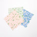 Ditsy Daisy Small Napkins in pastel pink, mint, and blue with white daisy prints, green leaves, and scalloped edges on a white background.