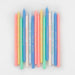 Birthday Phrases Candles in assorted pastel colors with printed birthday sayings arranged on a white background.