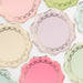 Ladurée Paris Side Plates in assorted pastel colors with wavy edges, metallic gold trim, and delicate gold garland details.

