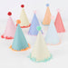 Large Party Hats arranged on a white background with pastel cone hats, colorful fringe trim, and fluffy pompom toppers.