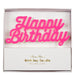 Pink Happy Birthday Candle in white packaging with hot pink script lettering mounted on clear cake picks.