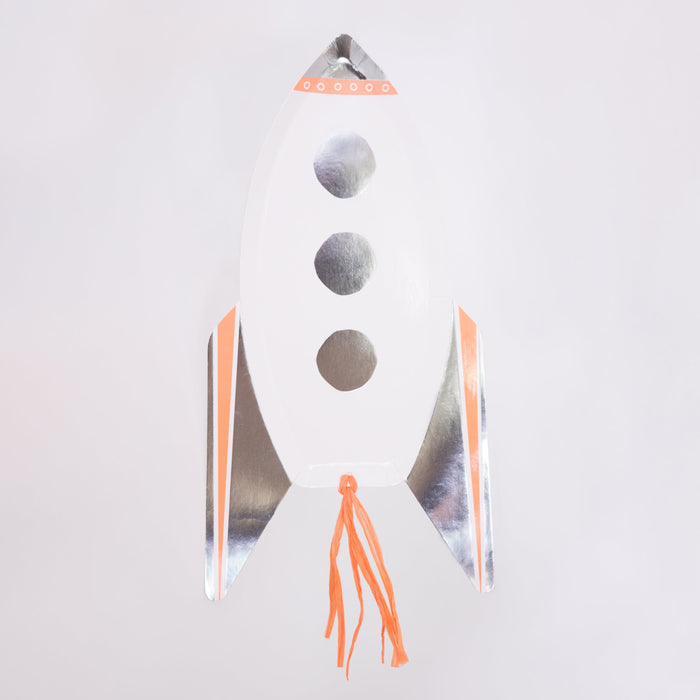 Rocket Plate shaped like a white rocket with shiny silver foil fins, orange accents, round window details, and orange tassel flames on a white background.