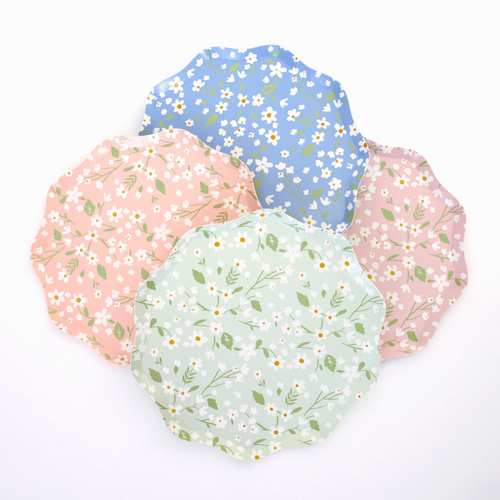 Ditsy Daisy Side Plates in assorted pastel pink, mint, blue, and mauve colors with white daisy prints and green leafy details on a white background.